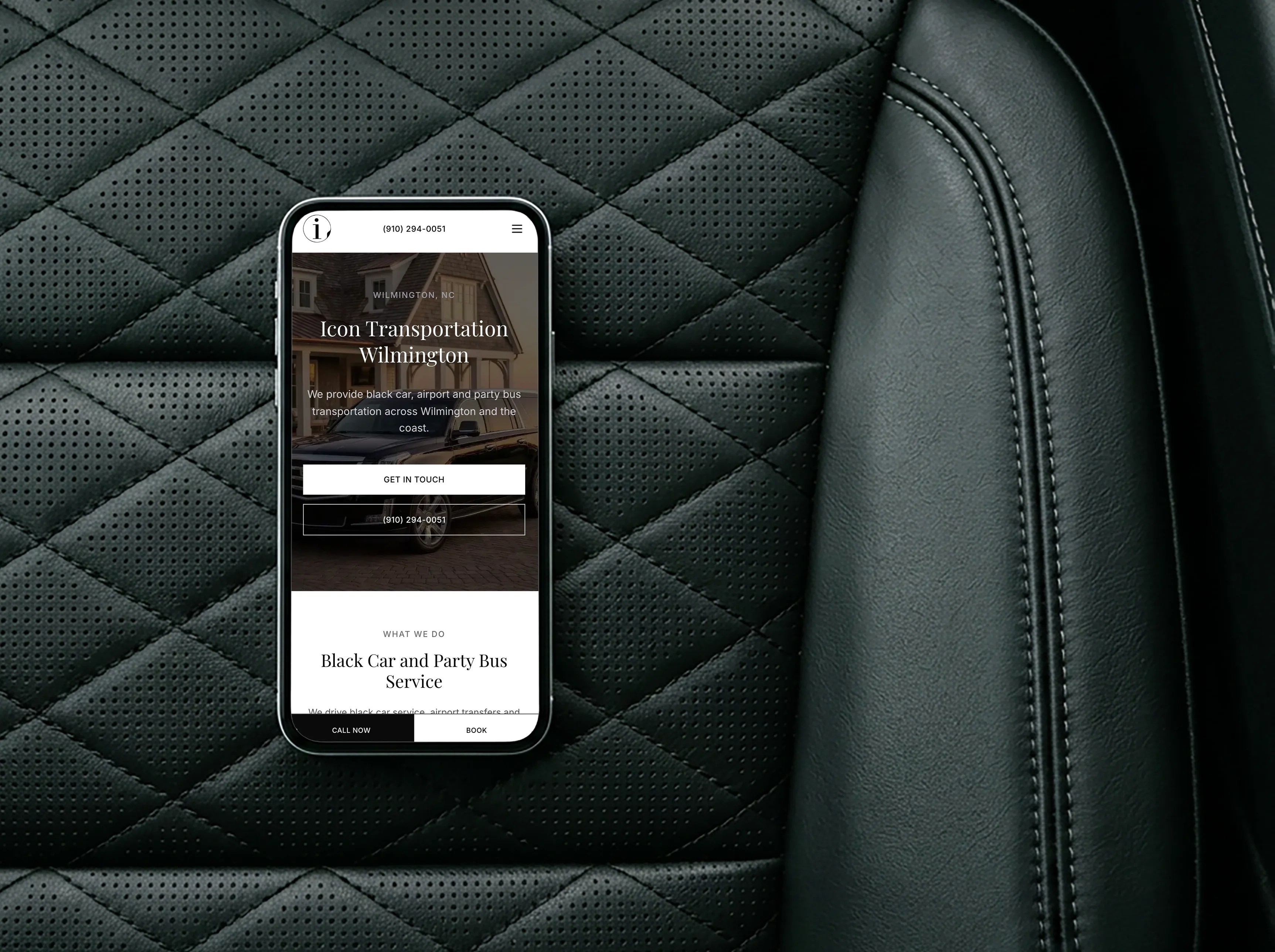 The Icon Transportation Wilmington website open on a phone, resting on the quilted leather seat of a black car
