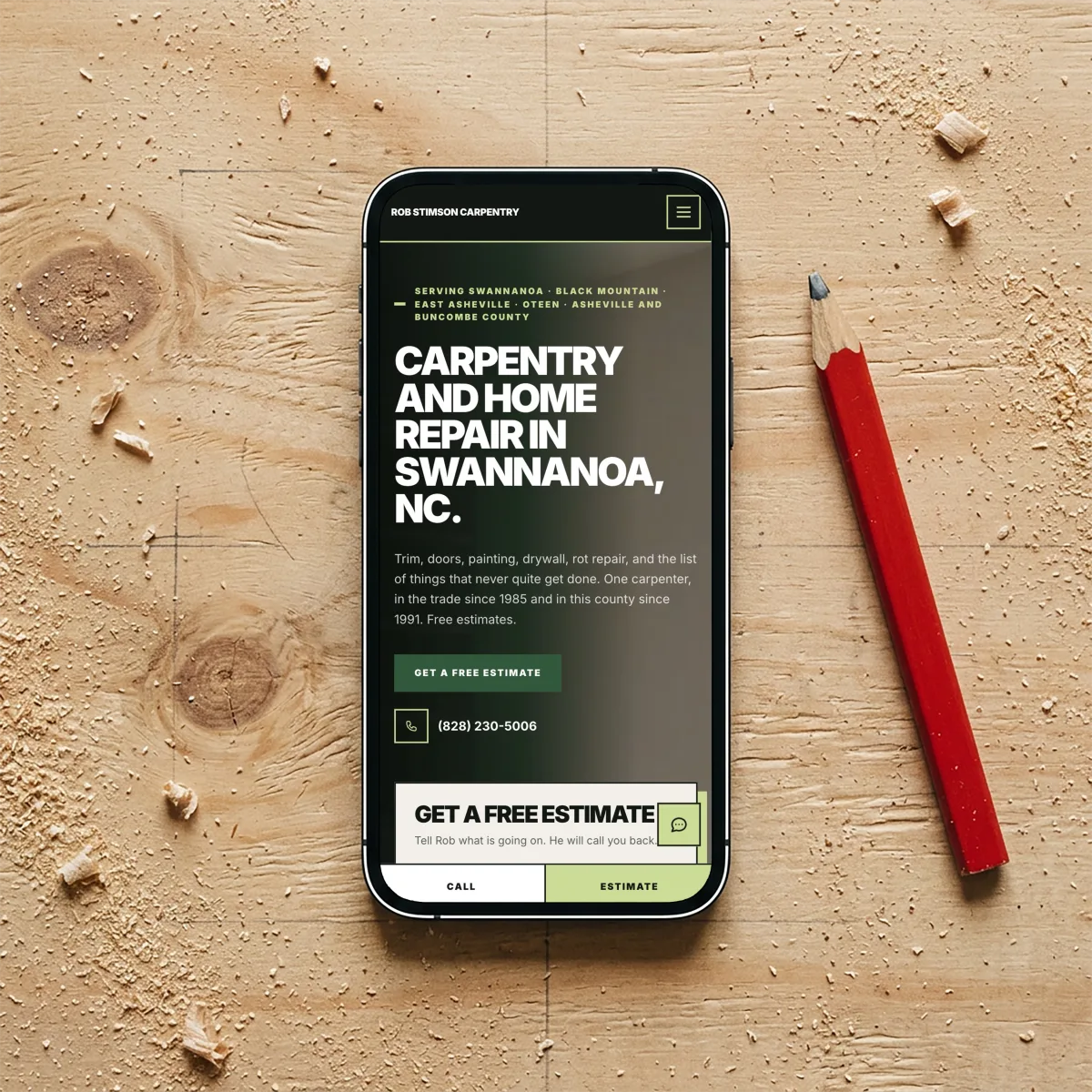 Rob Stimson Carpentry website on a phone, resting on a sawdust-covered workbench