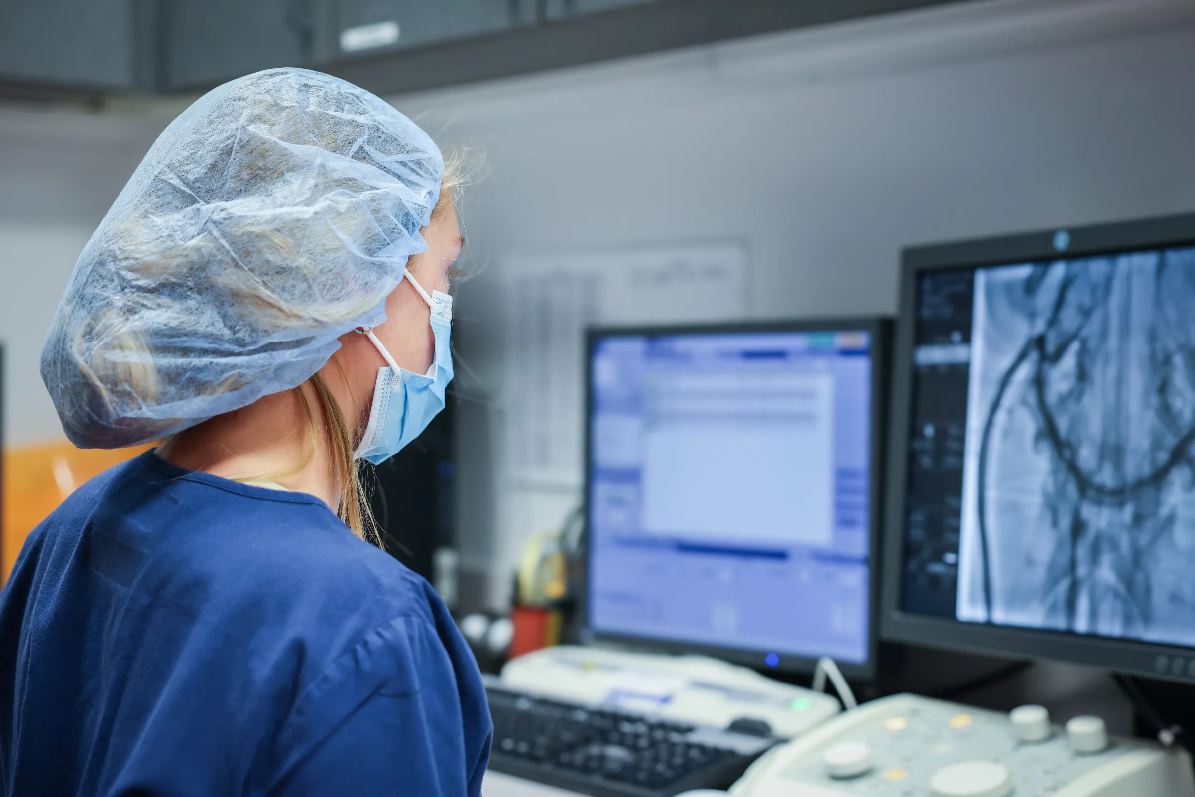 A Synchrony Labs clinician reviewing a coronary angiogram at the control station