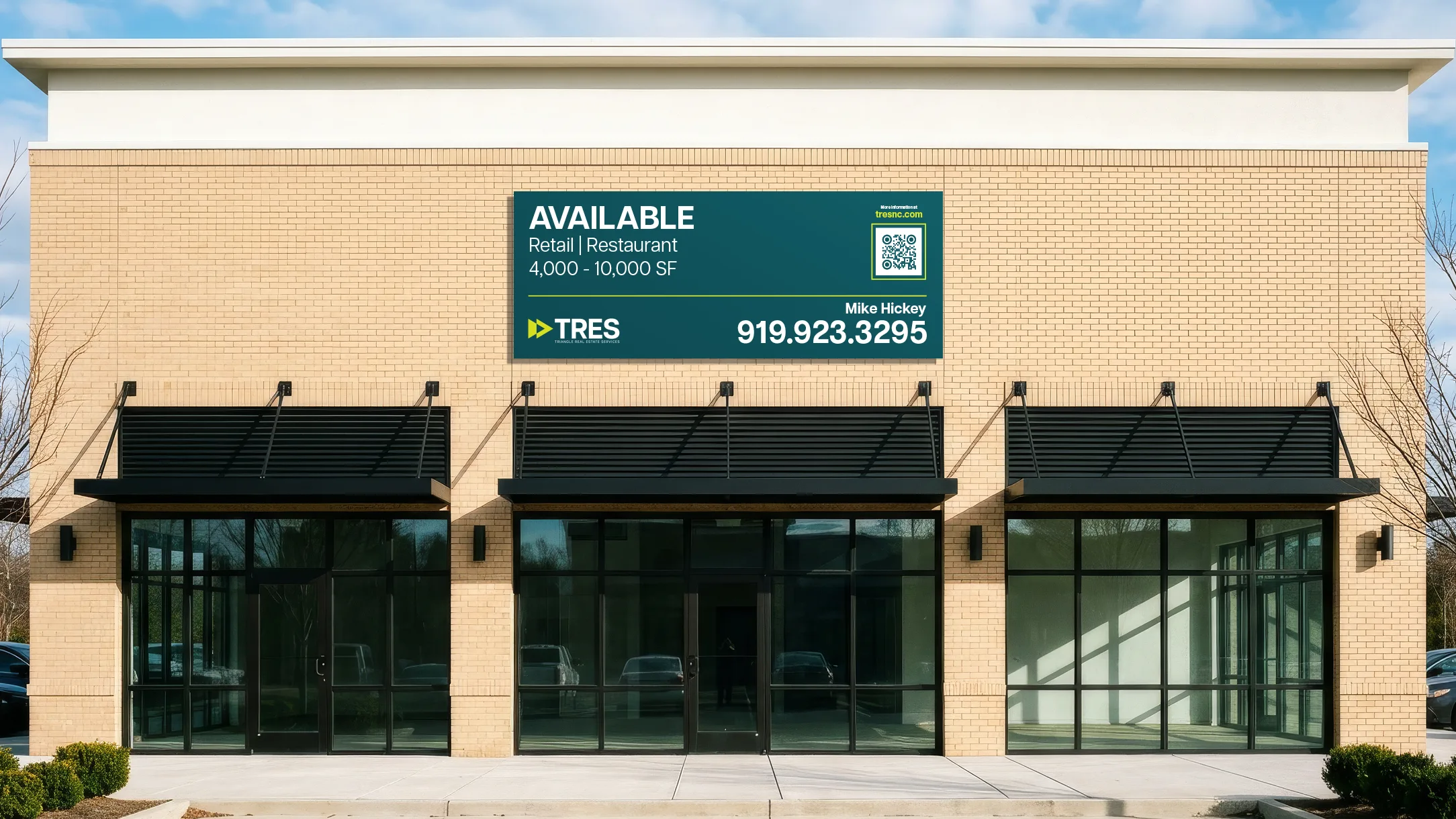 TRES storefront leasing signage on a retail building