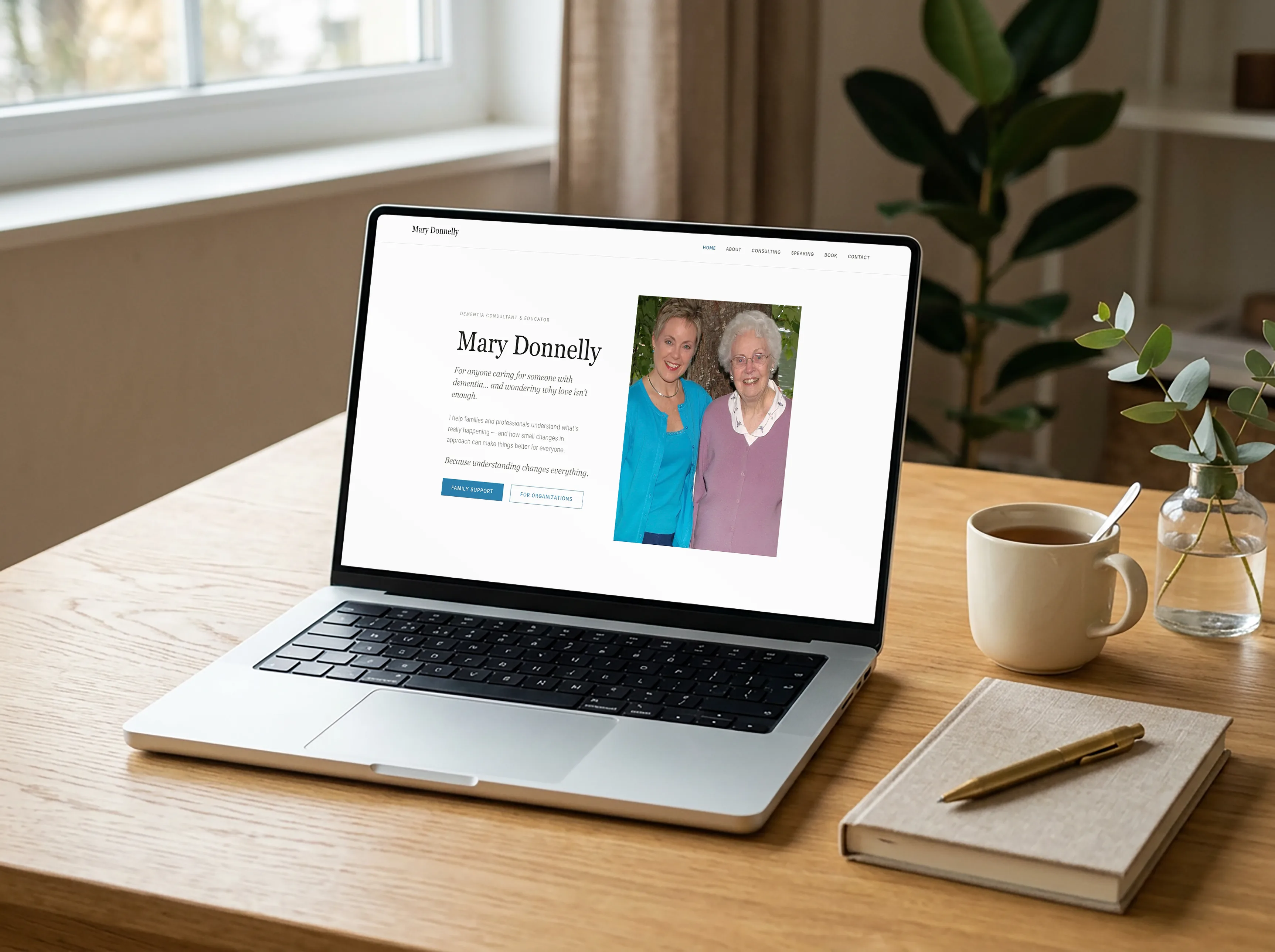 The Mary Donnelly dementia consulting homepage open on a laptop at a sunlit desk