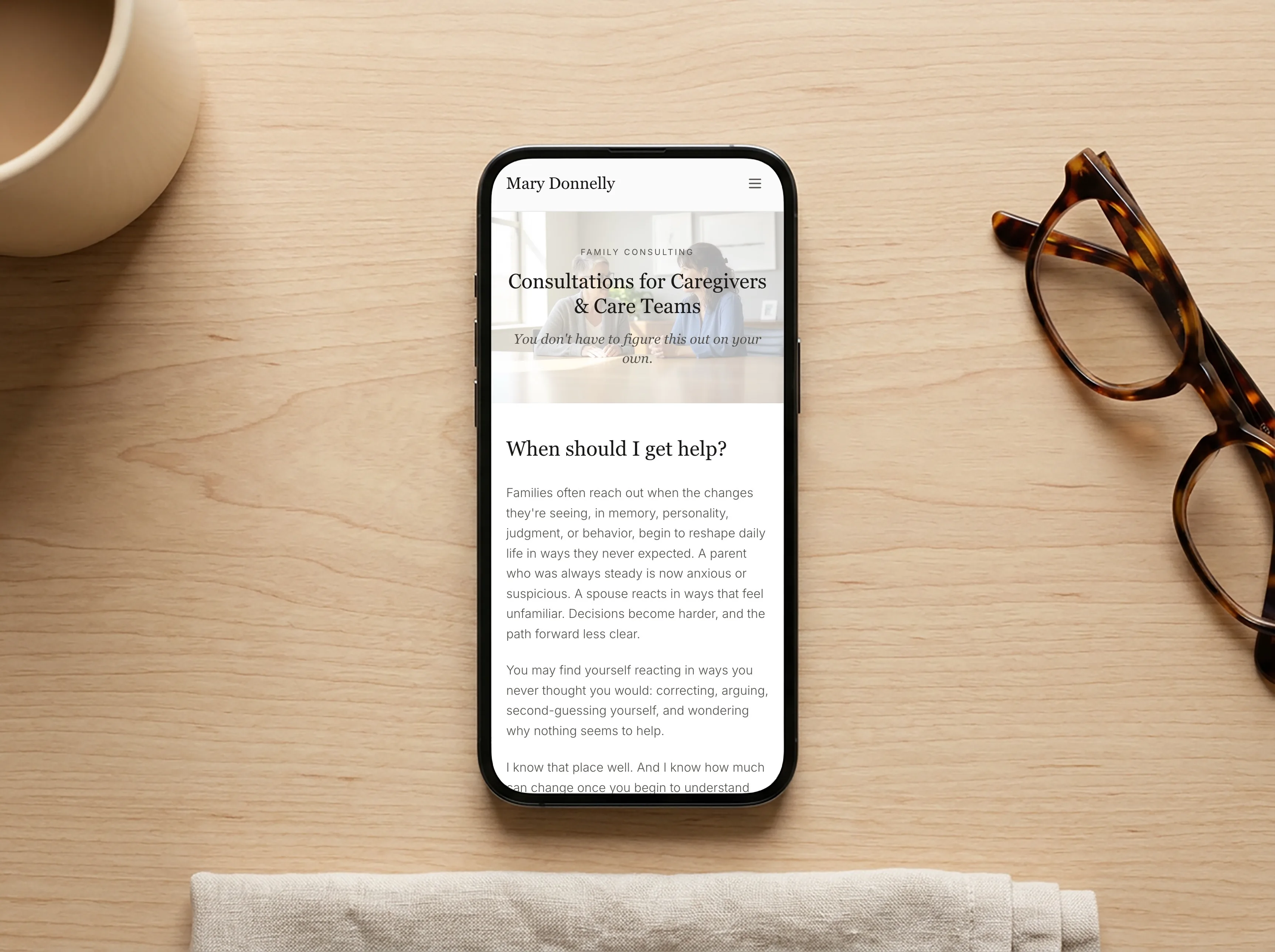 The Mary Donnelly dementia consulting page on a phone, set in Playfair Display and Inter for easy reading